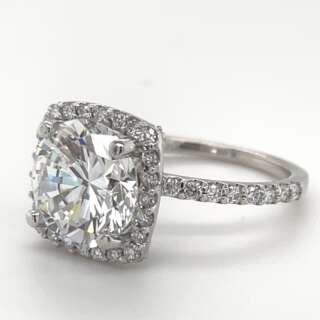 Ladies 14kt White gold with 4 carat Diamond Center with halo surrounding Diamonds.
