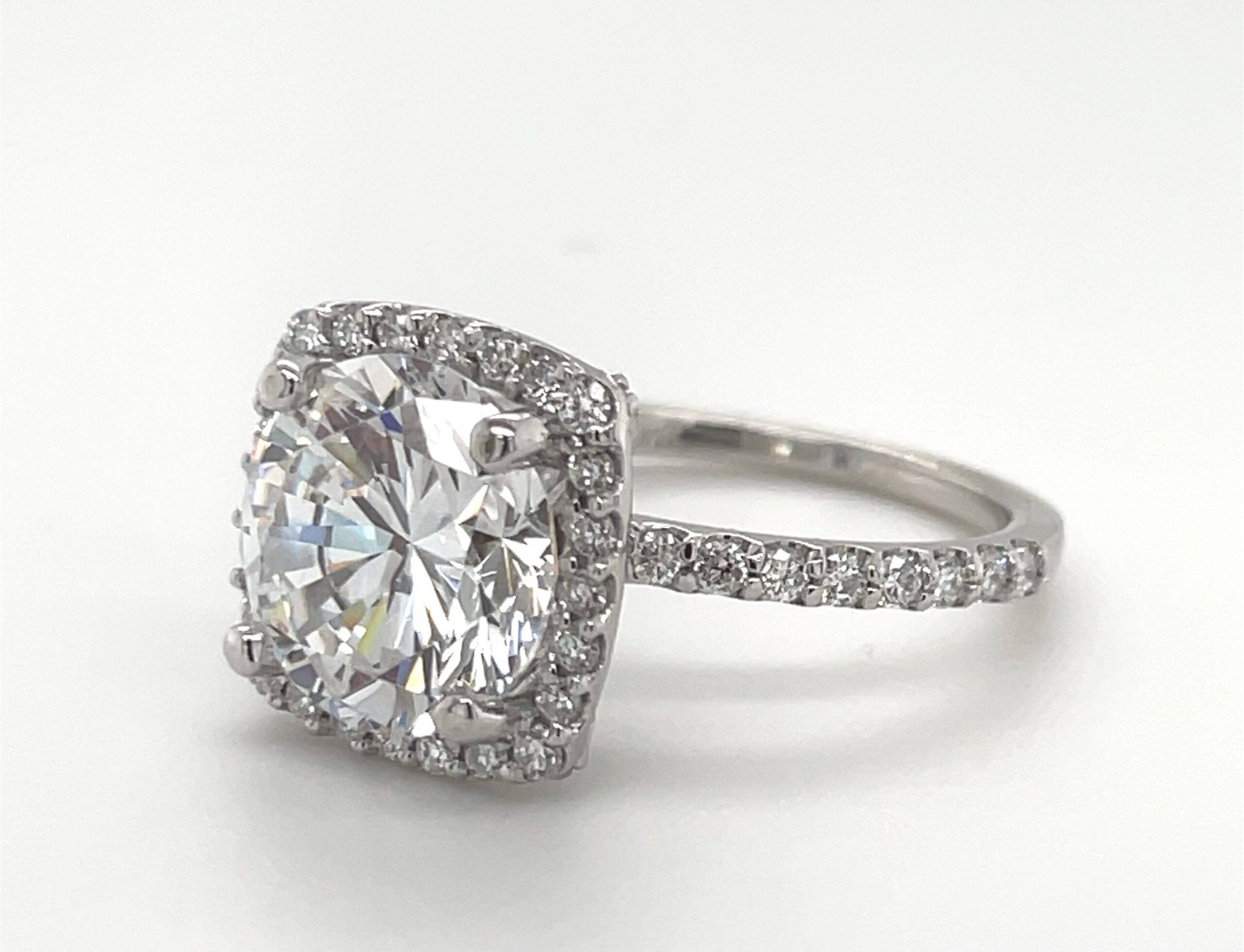 Ladies 14kt White gold with 4 carat Diamond Center with halo surrounding Diamonds.